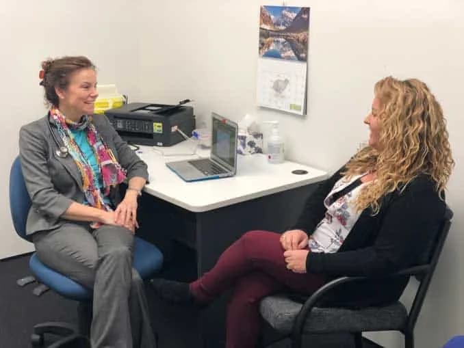 Dr. Jonie Girouard meeting with a patient in a clinic room, discussing Lipedema during a supportive and professional consultation.