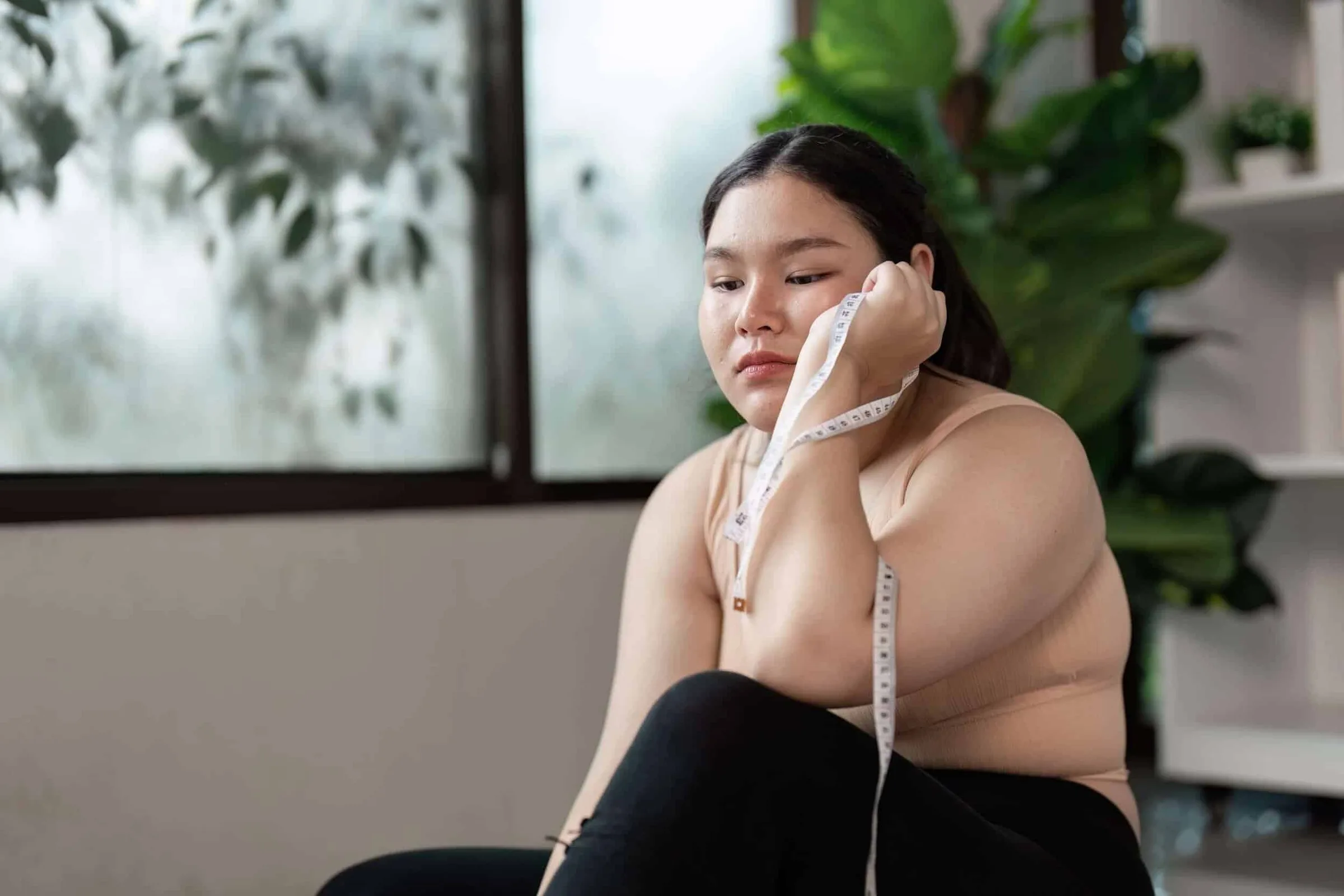 Obesity or Lipedema Sad lady with tape measure