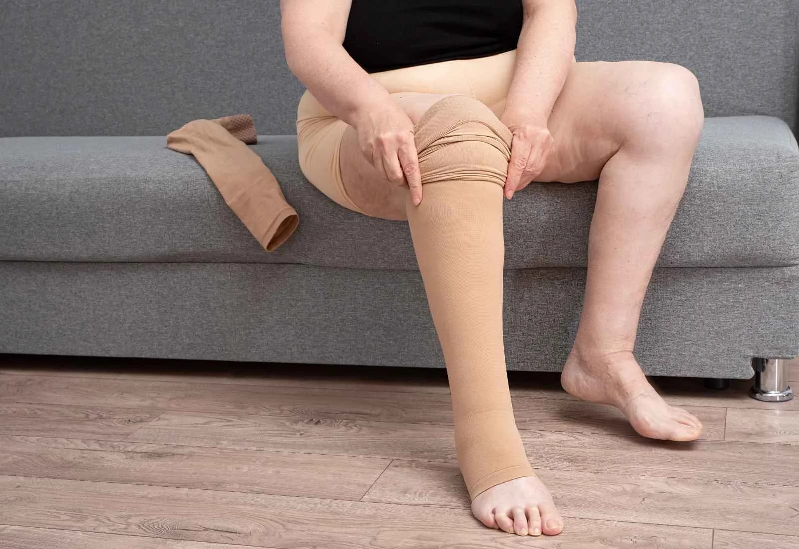 Woman putting on Micromassage Compression
